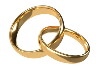 Golden wedding rings on white background